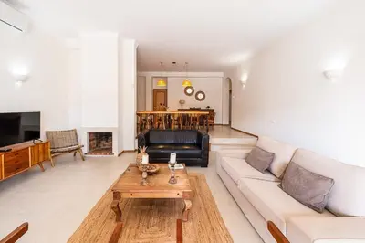 a living room with a couch and a coffee table at Villa Gale Grande - bright airy property with a private pool in Albufeira