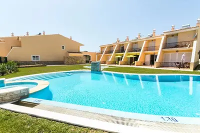 a large swimming pool in front of a building at Apartment Filipa III - Beachfront with Jacuzzi in Albufeira