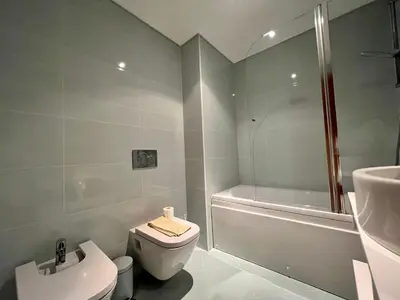 a bathroom with a toilet and a shower and a sink at Apartment Filipa III - Beachfront with Jacuzzi in Albufeira