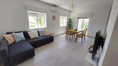 a living room with a couch and a table at Apartamento Kélyfos Beach by feriascomsol in Quarteira