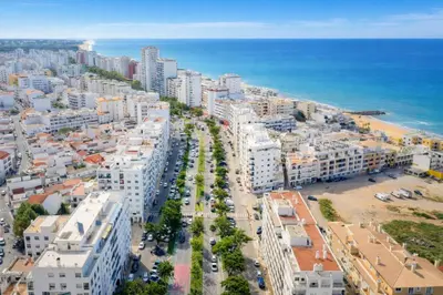 an aerial view of a city and the ocean at Apartamento Alameda in Quarteira