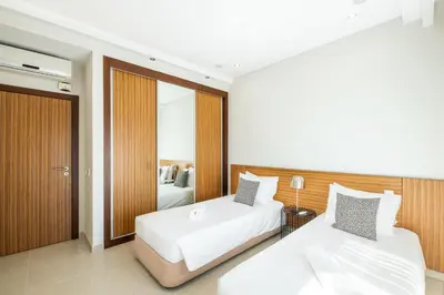 a hotel room with two beds and a mirror at Villa Adaro - Large Luxury close to marina in Albufeira