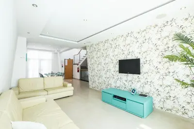 a living room with a couch and a tv on a wall at Villa Adaro - Large Luxury close to marina in Albufeira