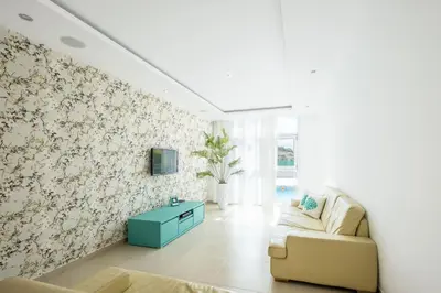 a living room with a couch and a tv on a wall at Villa Adaro - Large Luxury close to marina in Albufeira