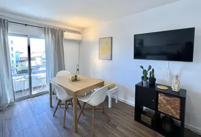 a dining room with a table and chairs and a television at Vista by the Nest - City Center HD PROPERTIES in Faro