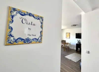 a living room with a painting on the wall at Vista by the Nest - City Center HD PROPERTIES in Faro