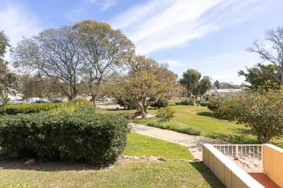a walkway in a park with trees and bushes at CORTEZ - Vilamoura in Vilamoura