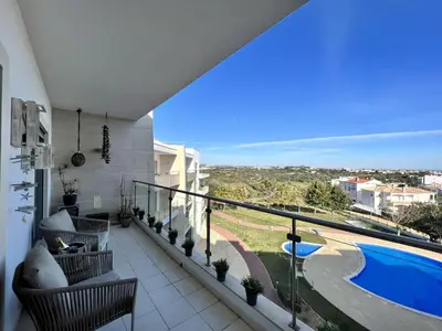 a balcony with a view of a swimming pool at Albufeira Forest View With Pool by Homing in Albufeira