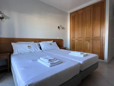 a bedroom with a bed with two towels on it at Sunset Bliss in Albufeira - Short walk to Oldtown in Albufeira