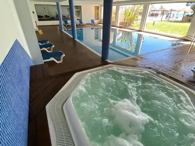a hot tub in the middle of a swimming pool at Sunset Bliss in Albufeira - Short walk to Oldtown in Albufeira