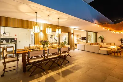 a dining room and living room with a table and chairs at Luxury Beach Villa - Casa do Forte- Infinity Pool sea view- Beach walking distance by DreamvillasAlbufeira in Albufeira