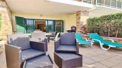 a group of chairs and tables on a patio at Los Olivos Del Golf 249- CleverDetails, Sleeps 6 Adults 1 Child in Vilamoura