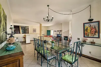 a living room with a glass table and chairs at Villa Almanda - Spacious villa perfectly located between Albufeira Marina and the Old Town in Albufeira