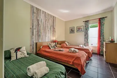 a bedroom with two beds and a window at Villa Almanda - Spacious villa perfectly located between Albufeira Marina and the Old Town in Albufeira