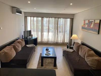 a living room with a couch and a table at Vilamoura Apartamento Algarve 311 in Vilamoura
