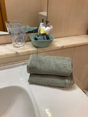 a bathroom sink with a pile of towels on it at Vilamoura Apartamento Algarve 311 in Vilamoura