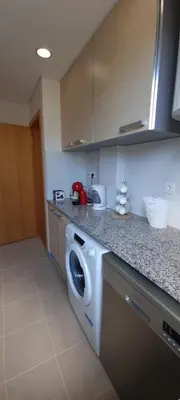 a kitchen with a washer and dryer on a counter at Star Dreams Albufeira in Albufeira