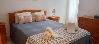 a bedroom with a large bed with two pillows on it at Maré Alta by CS in Olhos de Água