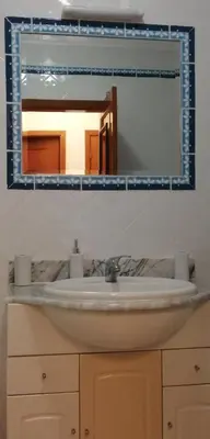 a bathroom sink with a mirror above it at Maré Alta by CS in Olhos de Água