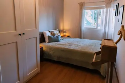 a bedroom with a large bed and a window at Starry Nights Apartment in Albufeira