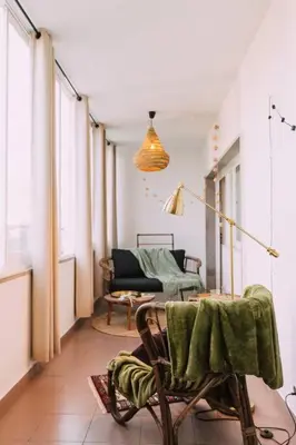 a living room with a chair and a couch at Starry Nights Apartment in Albufeira