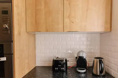 a kitchen with a counter top with a toaster and a toaster at Starry Nights Apartment in Albufeira