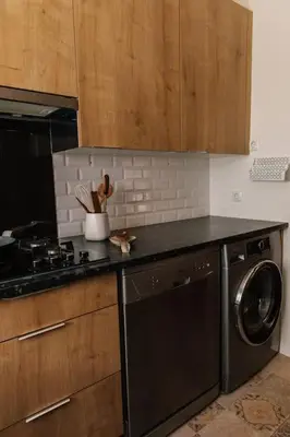 a kitchen with a dishwasher and a washer in it at Starry Nights Apartment in Albufeira