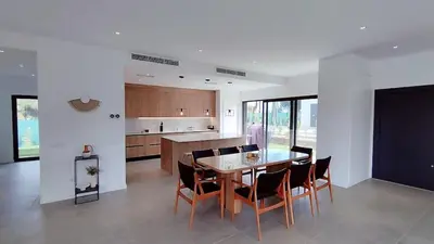 a kitchen and dining room with a table and chairs at Valverde 3 Villa, Vilamoura, Algarve, only 5 minutes from Marina, Golf and Beach in Quarteira
