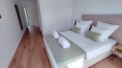 a bedroom with a large bed with white pillows at Valverde 3 Villa, Vilamoura, Algarve, only 5 minutes from Marina, Golf and Beach in Quarteira