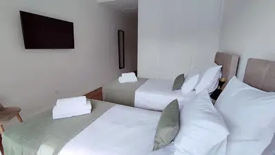 a hotel room with two beds and a flat screen tv at Valverde 3 Villa, Vilamoura, Algarve, only 5 minutes from Marina, Golf and Beach in Quarteira