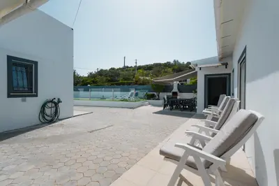 a living room with a couch and a coffee table at Casas Caiado Two Houses with swimming POOL in Faro