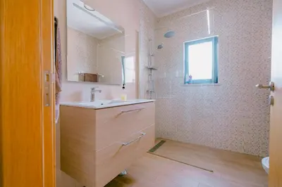 a white house with a green door at Casas Caiado Two Houses with swimming POOL in Faro