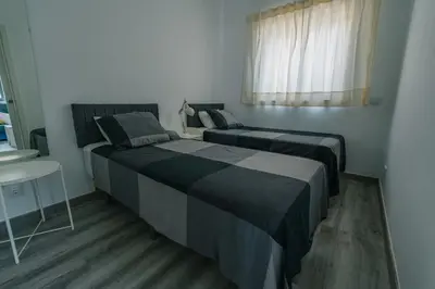 a living room with a flat screen tv on the wall at Casas Caiado Two Houses with swimming POOL in Faro