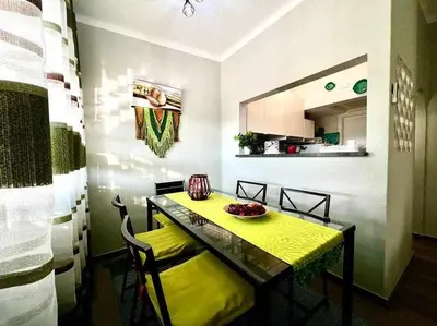 a dining room with a yellow table and chairs at Green House by FHR estacionamento e WI-FI in Quarteira