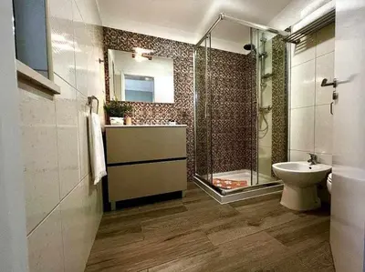 a bathroom with a shower and a sink and a toilet at Green House by FHR estacionamento e WI-FI in Quarteira