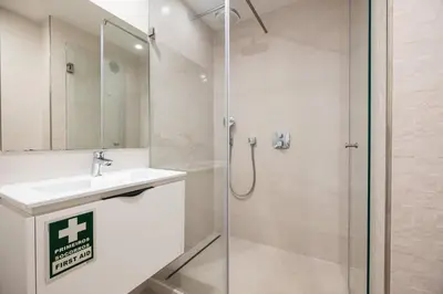 a bathroom with a sink and a shower at Al Marina View Uma - Lux apartment on the marina in Páteo