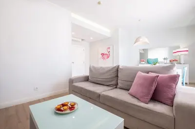 a living room with a couch and a table at Al Marina View Uma - Lux apartment on the marina in Páteo
