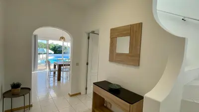 a living room with a staircase leading to a dining room at Nicola by Check-in Portugal in Albufeira