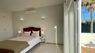 a bedroom with a bed and a large window at Nicola by Check-in Portugal in Albufeira