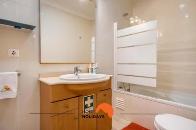 a bathroom with a sink and a toilet and a mirror at #123 T2 Pão das Areias by Home Holidays in Albufeira