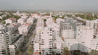 a balcony with a view of the ocean and buildings at Divine Quarteira Sea View By JG Apartments in Quarteira