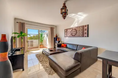 a living room with a couch and a table at AlgarSun - idealy situated holiday apartment with all modern comfort in Albufeira