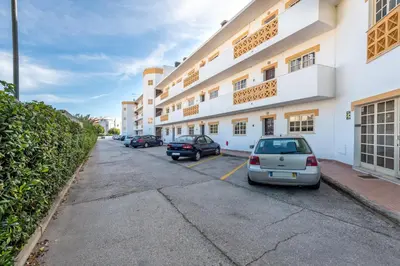 a row of cars parked in front of a building at AlgarSun - idealy situated holiday apartment with all modern comfort in Albufeira