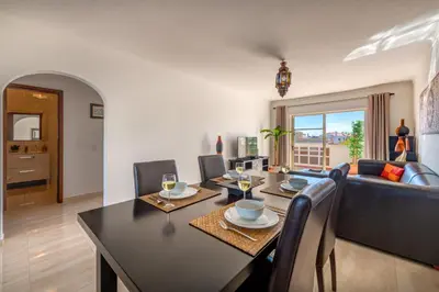 a living room with a table and a couch at AlgarSun - idealy situated holiday apartment with all modern comfort in Albufeira