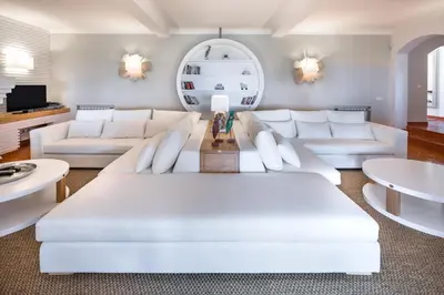 a living room with white furniture and a white couch at Shantivillas Malhão in Azinhal