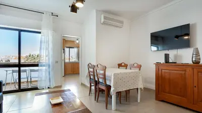 a kitchen and dining room with a table and chairs at Sun-kissed Oasis W/ Pool by LovelyStay in Albufeira