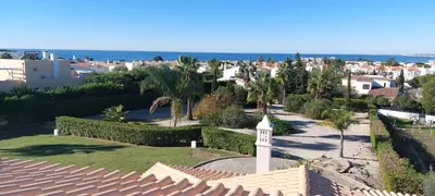 a view from the roof of a house with a clock tower at Baia Village - Galé - Albufeira in Albufeira