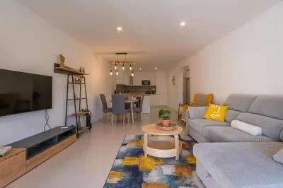 a living room with a couch and a tv at Lemon House - 400m from the Beach - Wifi in Albufeira