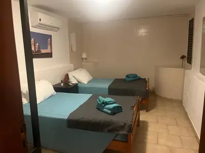 two beds in a hotel room with towels on them at Villa Amarela in Vilamoura