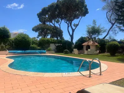 a small swimming pool in a yard with trees at Villa Amarela in Vilamoura